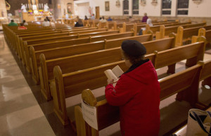 WOMAN PRAYS IN PEW AT WISCONSIN SHRINE